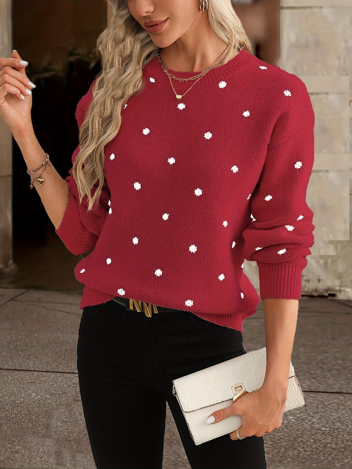 Close-up of a soft women's polka dot knit sweater featuring a classic round neck.