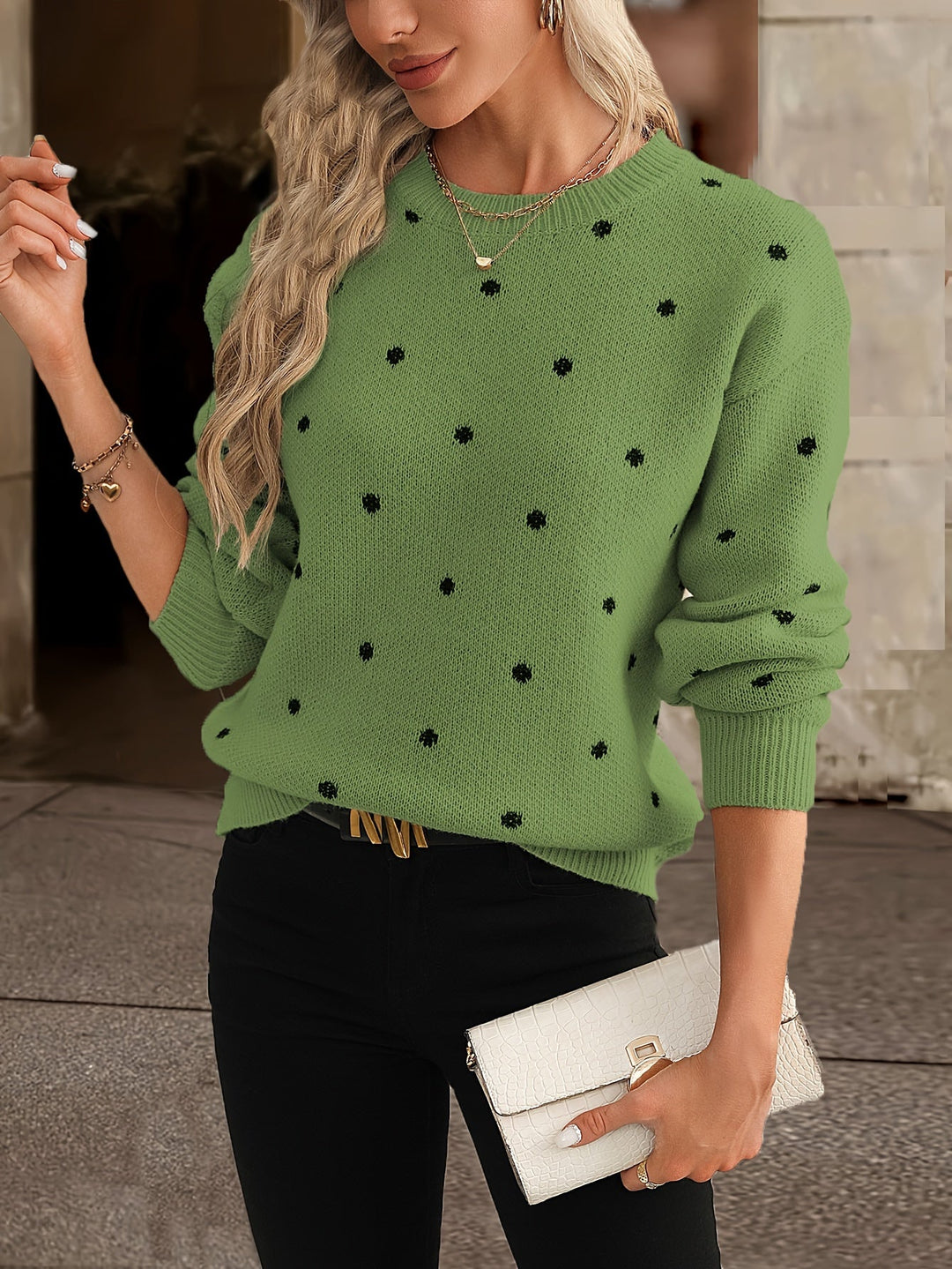 Model wearing a trendy women's polka dot long sleeve sweater for cozy winter style.