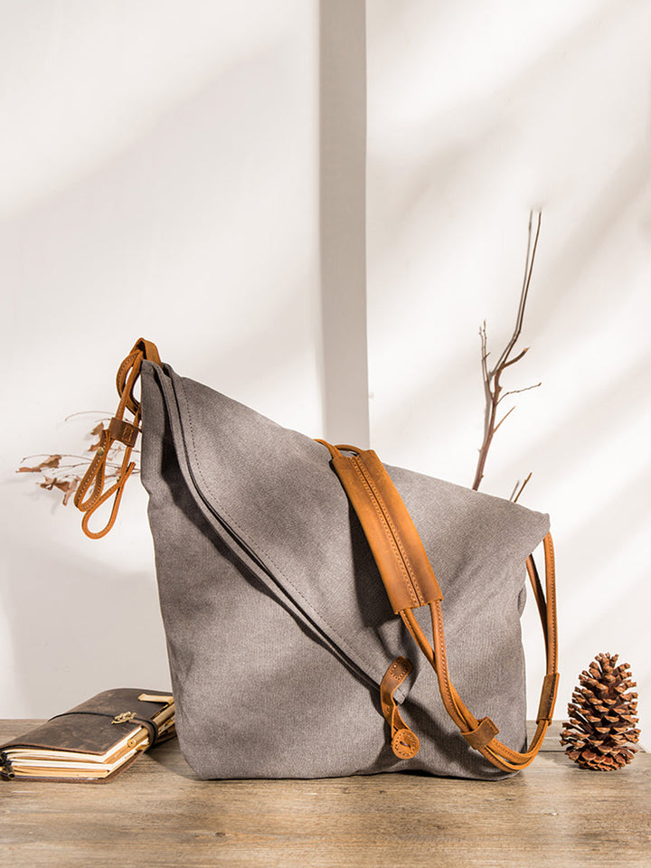 Women's black asymmetrical slouchy shoulder bag, adjustable strap, perfect for everyday style.
