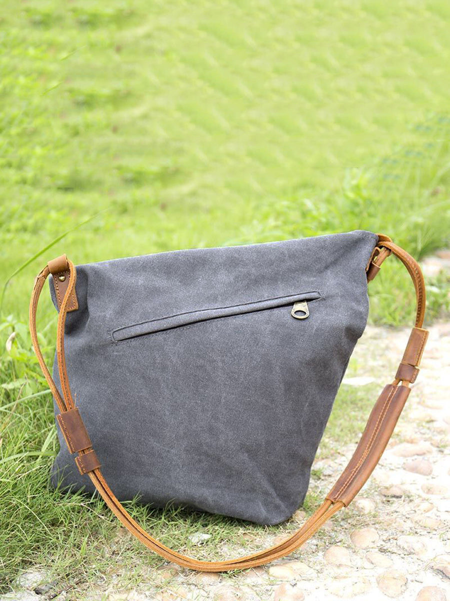 Close-up of the material and craftsmanship on a women's tan slouchy shoulder bag with adjustable strap.