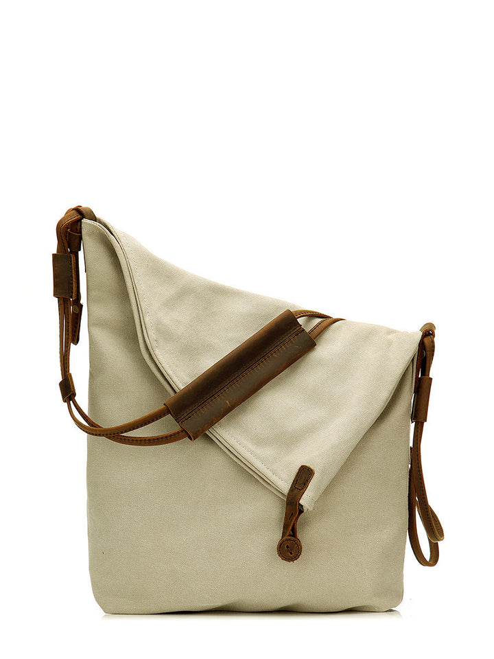 Close-up of a women's navy asymmetrical slouchy bag, showing the unique design & texture.