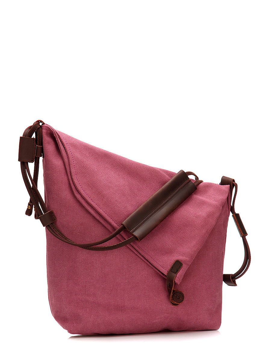Model carrying a chic women's black slouchy shoulder bag, asymmetrical shape, adjustable for comfort.