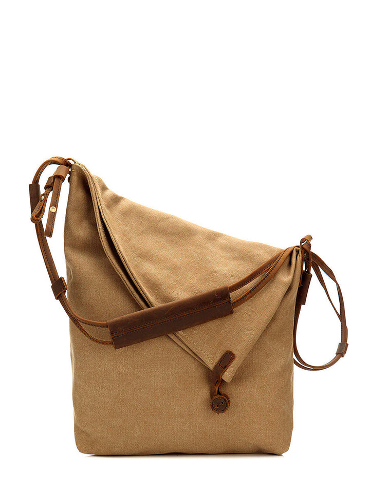 Front view of a women's tan asymmetrical slouchy shoulder bag, versatile with an adjustable strap.