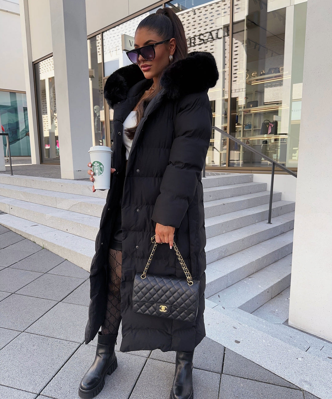 Women's black belted maxi puffer winter coat, quilted for warmth & style.