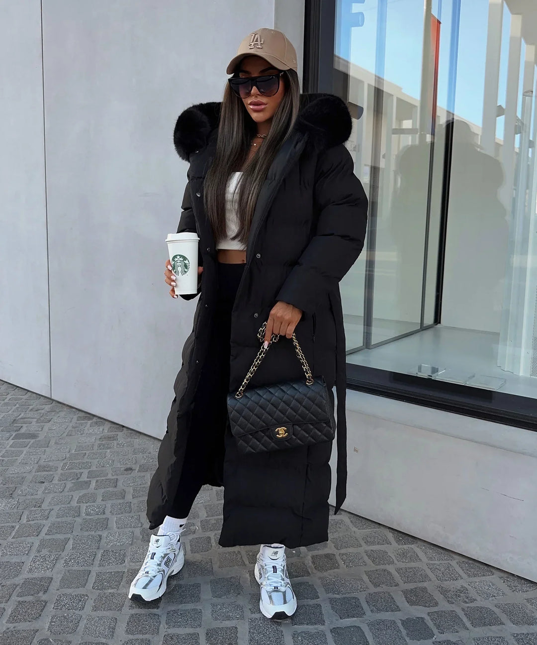 Comfortable women's black belted maxi puffer coat, warm quilted outerwear for winter.