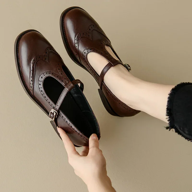 Women's black Brogue T-Strap Mary Jane shoes with a low block heel & buckle. Classic, vintage-inspired style.