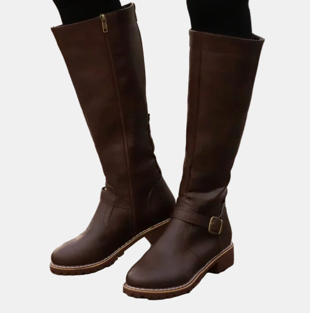 Stylish women's winter boots, knee-high design with multiple buckle straps and a practical low heel.
