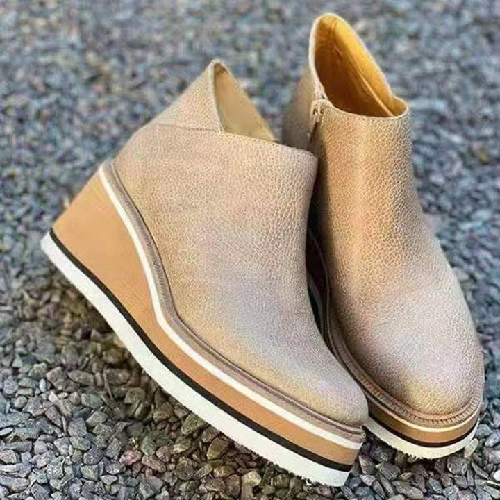 Modern women's ankle boots with a stylish chunky heel, durable sole, and convenient zipper access.