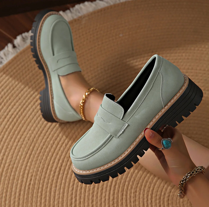 Black women's platform loafers with chunky sole. Slip-on for stylish, versatile smart casual looks.