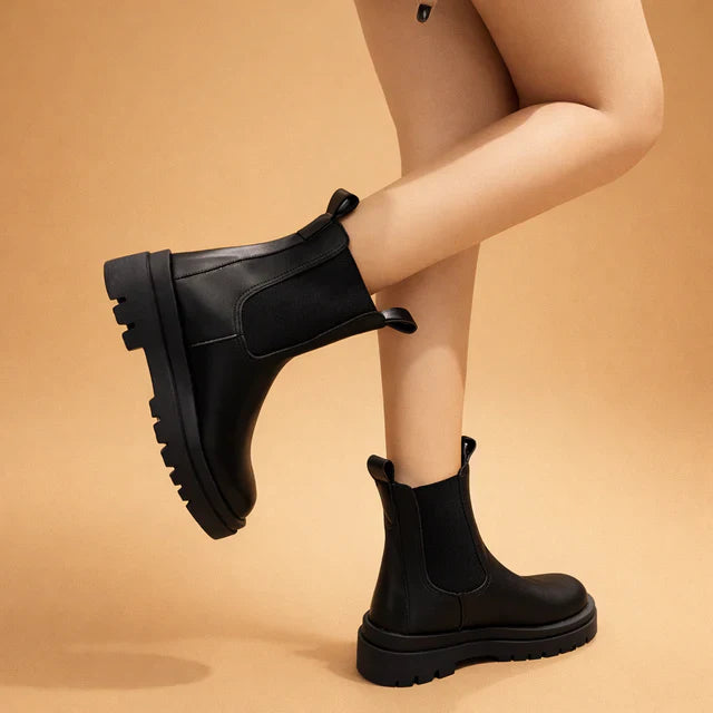Women's black elegant high ankle boots, comfortable slip-on design for easy wear.