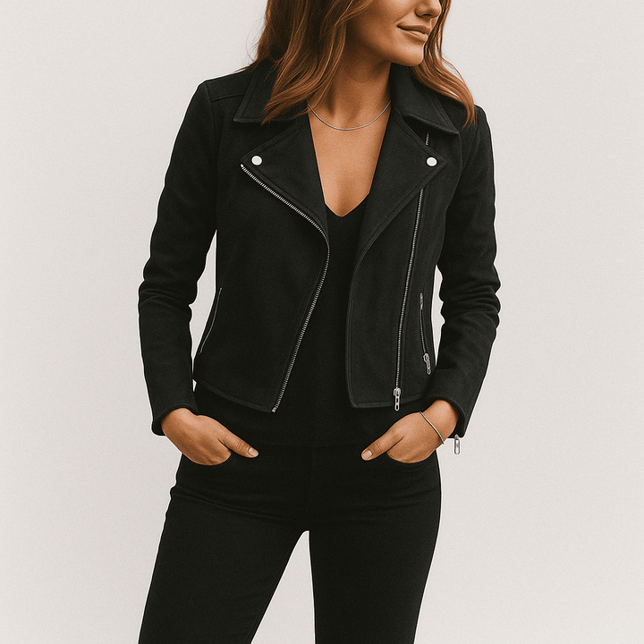 Model posing in an edgy women's faux suede biker jacket with silver hardware