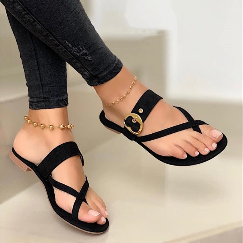 Women's black flat strap sandals with stylish buckle detail and open toe, perfect for summer casual wear.