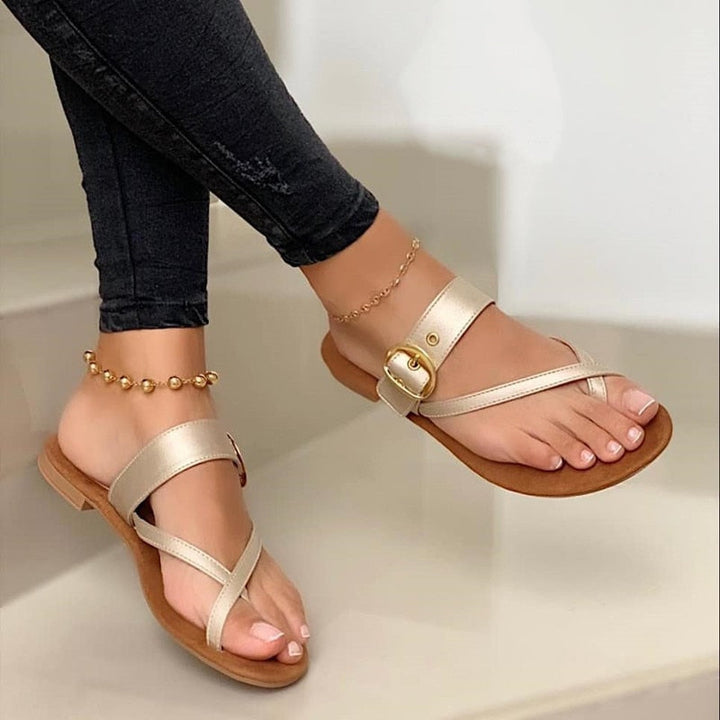 Comfortable women's gold flat strap sandals, ideal for everyday summer wear, vacation, or beach outings.