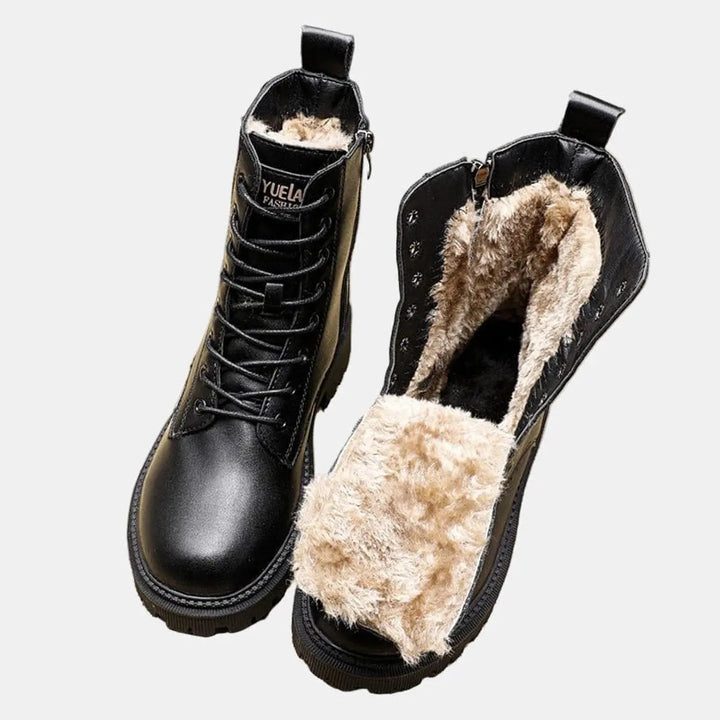 Women's black fur-lined lace-up combat ankle boots with chunky sole, perfect for stylish winter fashion.
