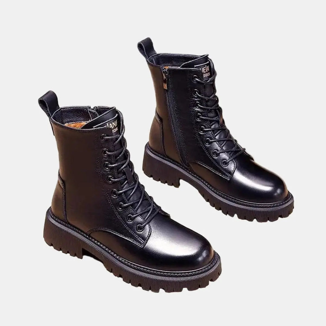 Edgy black combat ankle boots for women, featuring a cozy fur lining, lace-up closure & durable chunky sole.