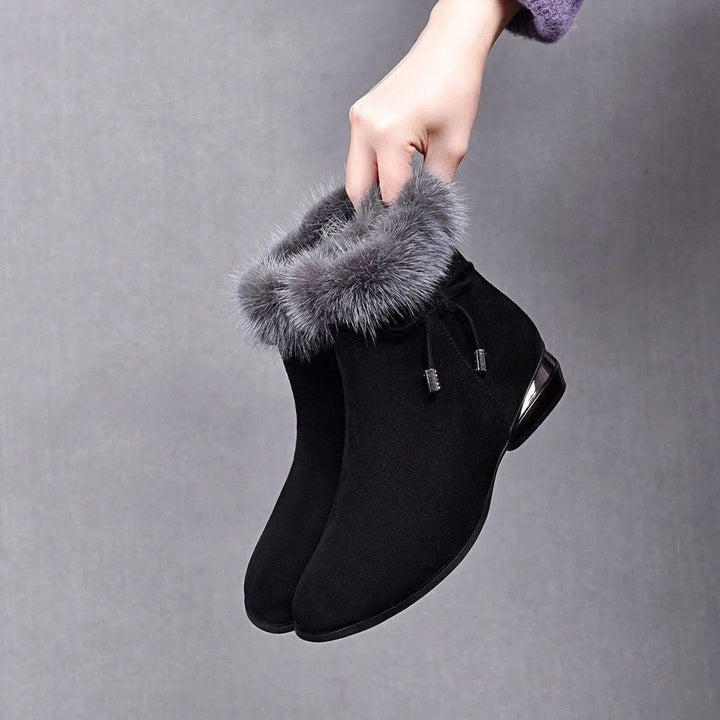 Women's black fur-trim flat ankle boots for cozy winter style. Warm, comfortable everyday casual footwear.