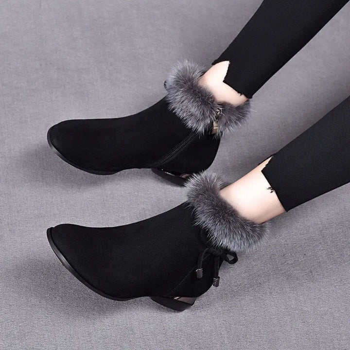 Cozy women's flat ankle boots with soft fur trim in black. Ideal warm winter boots for casual everyday wear.