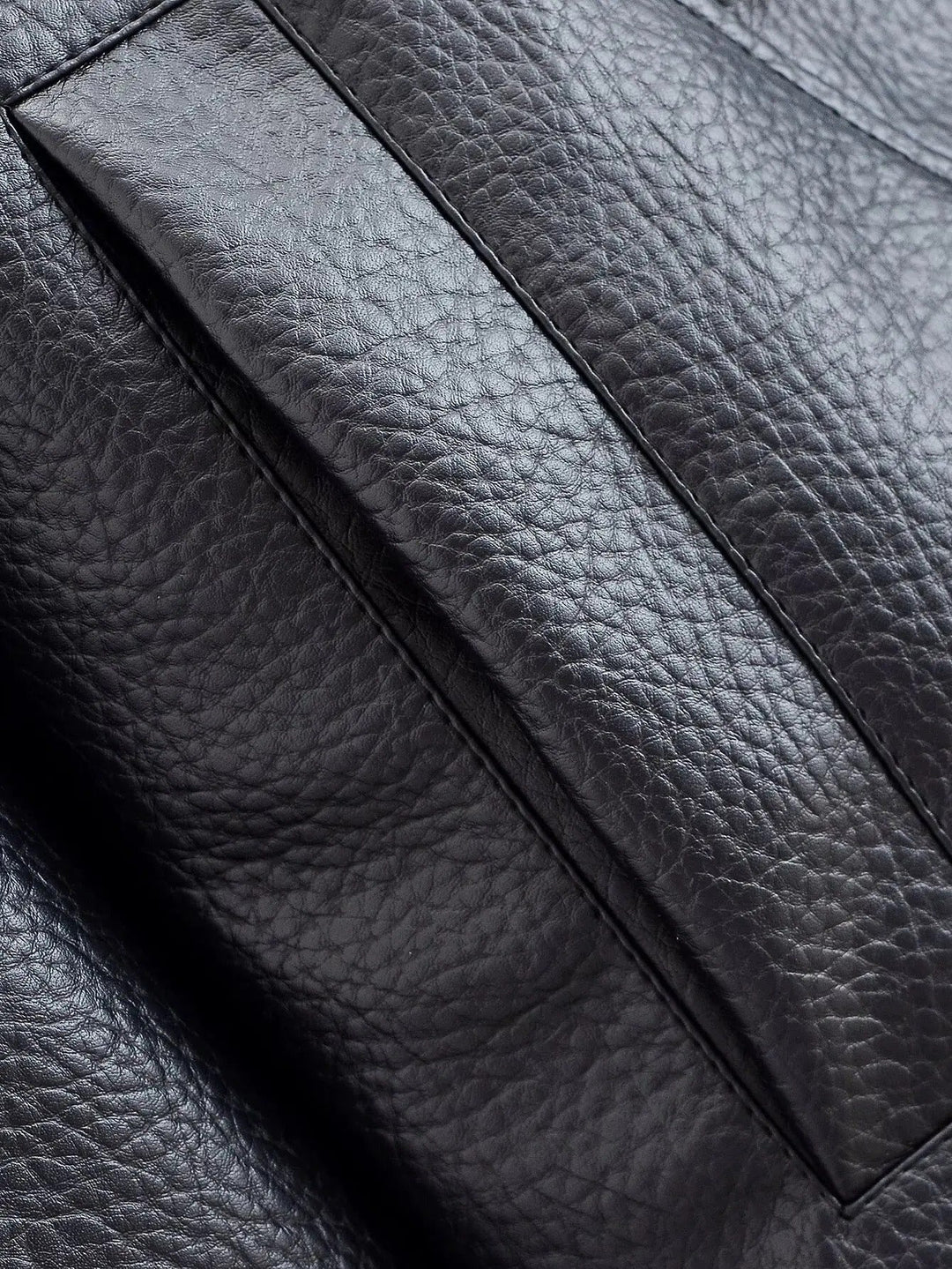 Textured black leather high neck jacket for women, a sleek and modern outerwear piece.
