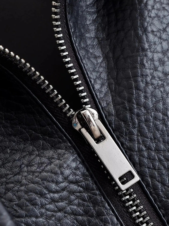 Full length view of a woman in a sleek black high neck leather jacket, modern and chic outerwear.