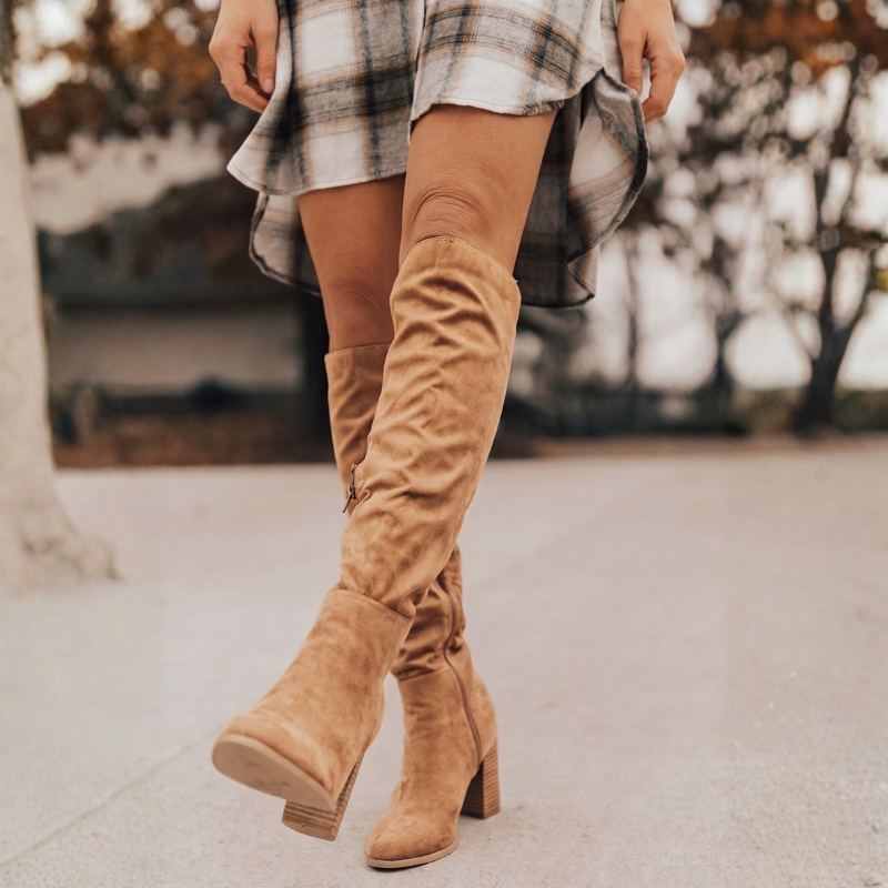 Elegant women's knee high slouch boots, featuring a practical side zipper and sturdy block heel for winter style.