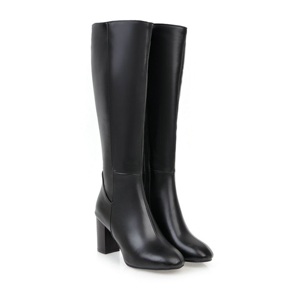 Close-up of women's knee-high boots showcasing the textured material and block heel.