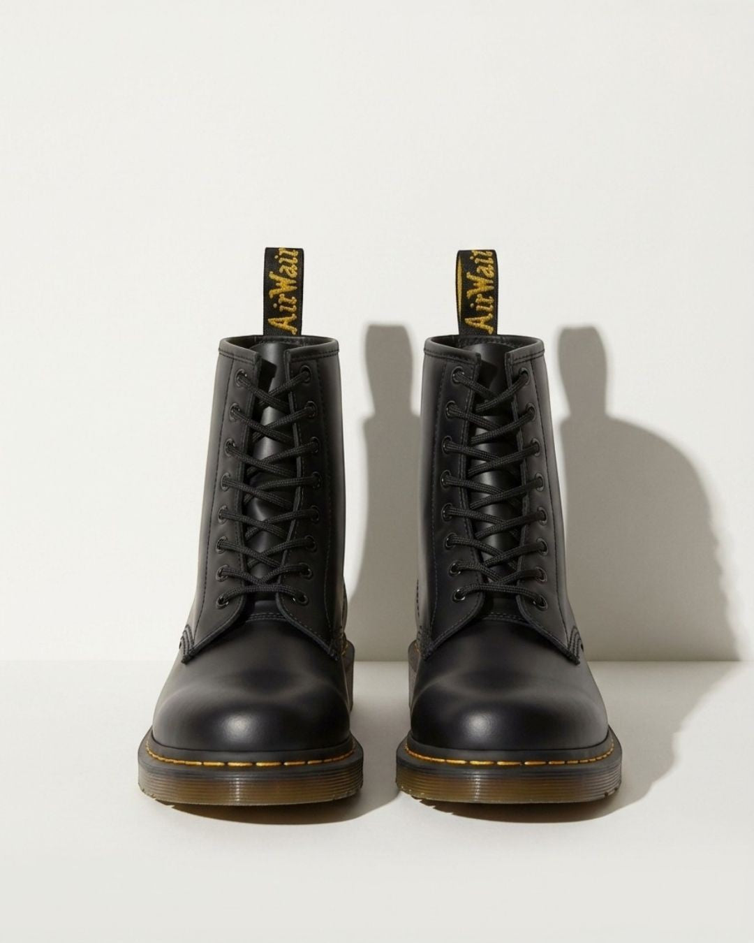 Women's black lace-up ankle combat boots with a chunky sole, perfect for urban style & autumn fashion.