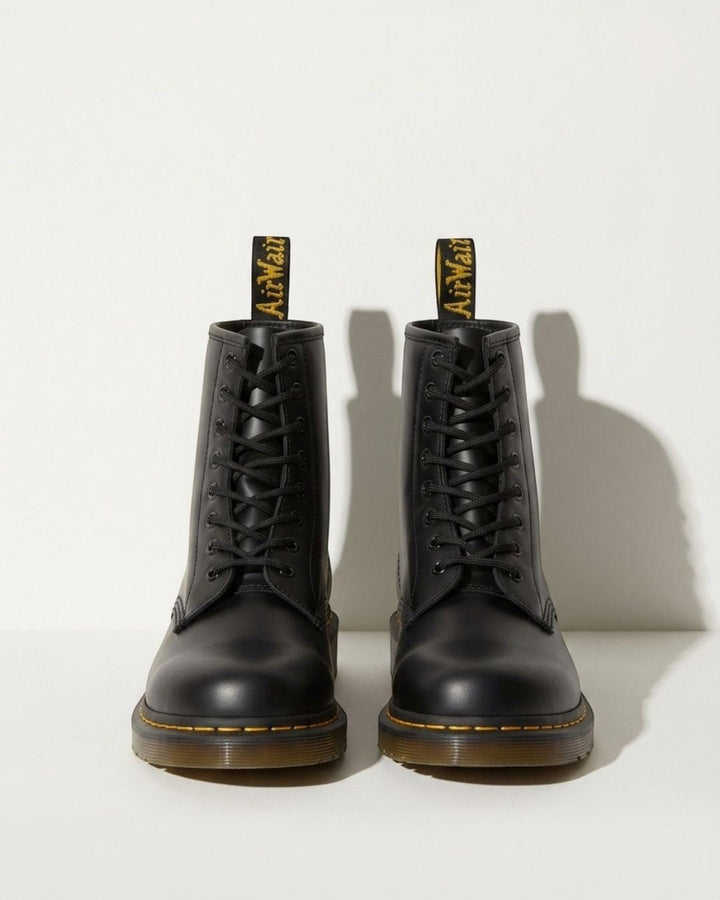 Women's black lace-up ankle combat boots with a chunky sole, perfect for urban style & autumn fashion.