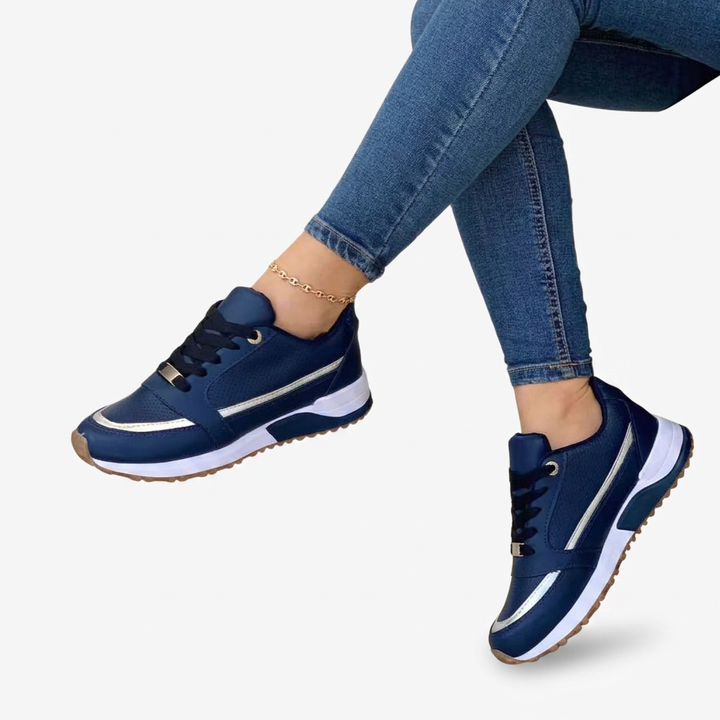 Women's black lace-up comfort sneakers with stylish metallic accents and a comfy platform sole.