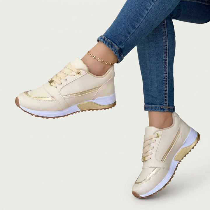 Comfortable black women's sneakers, perfect for walking. Features lace-up design and subtle metallic fashion details.