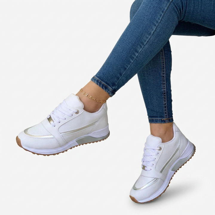 Fashionable black women's sneakers with secure lace-up closure & subtle metallic accents. Ideal for casual comfort.