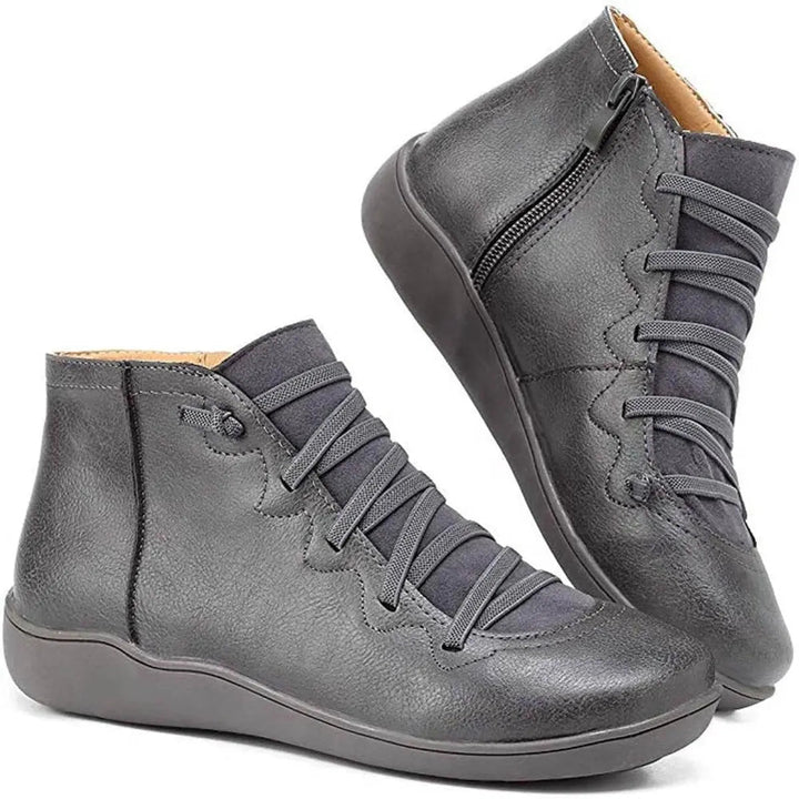 Comfortable women's flat ankle boots with lace-up design and side zip, ideal for casual everyday wear.