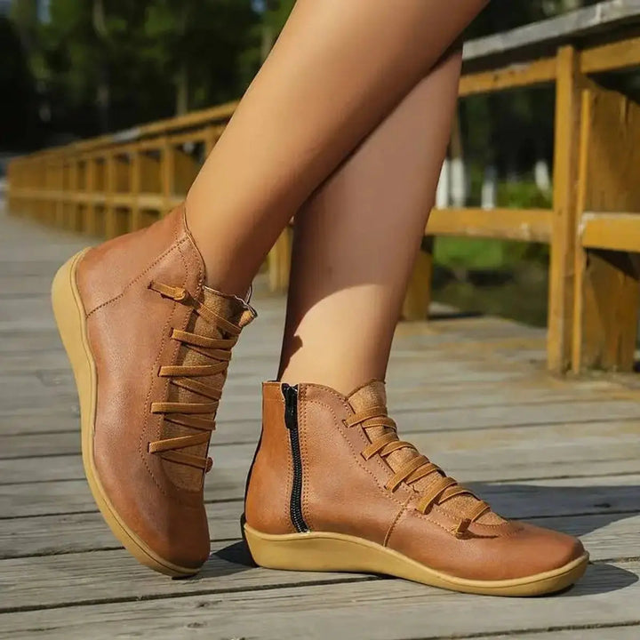 Full view of women's flat lace-up ankle boots with side zip, great for casual autumn & winter fashion.