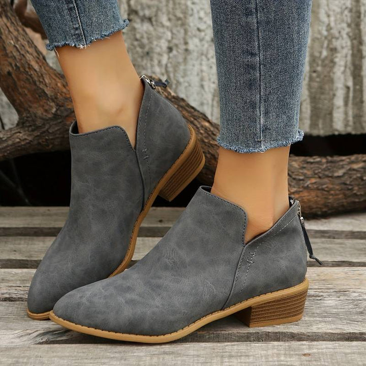 Elegant women's ankle boots featuring a sleek pointed toe & comfortable low block heel. Perfect for fashion looks.