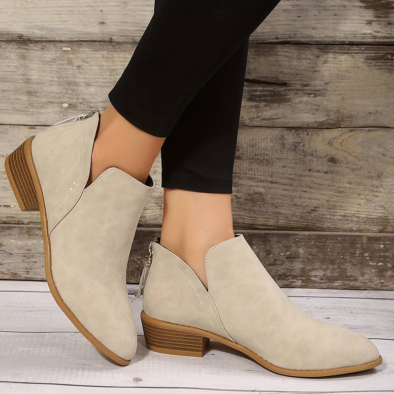 Stylish women's low heel ankle boots with a pointed toe, perfect for adding a chic touch to any outfit.