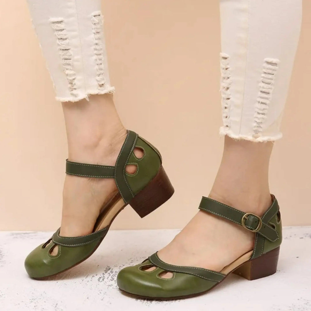 Fashionable women's Mary Jane flats, sleek design with a secure ankle strap and unique cutout embellishments.