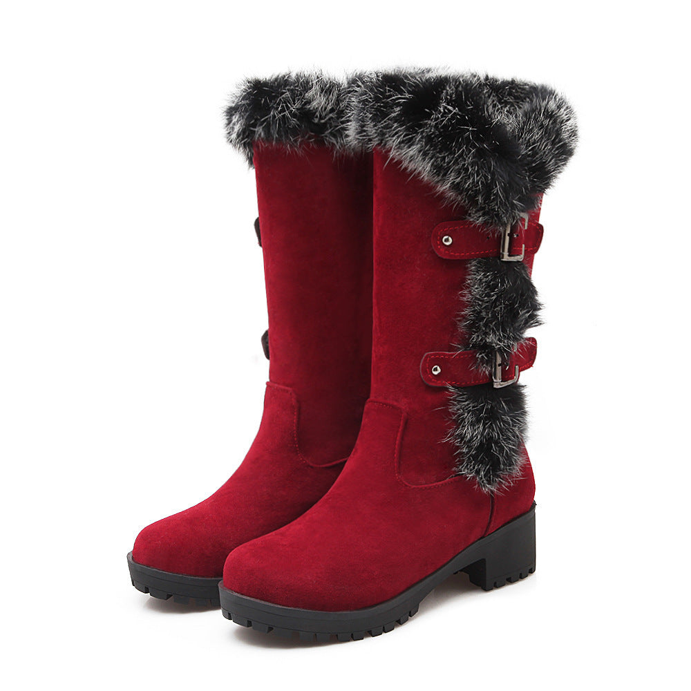 Women's black mid-calf winter boots with faux fur trim, decorative buckles, and sturdy sole for cold weather.