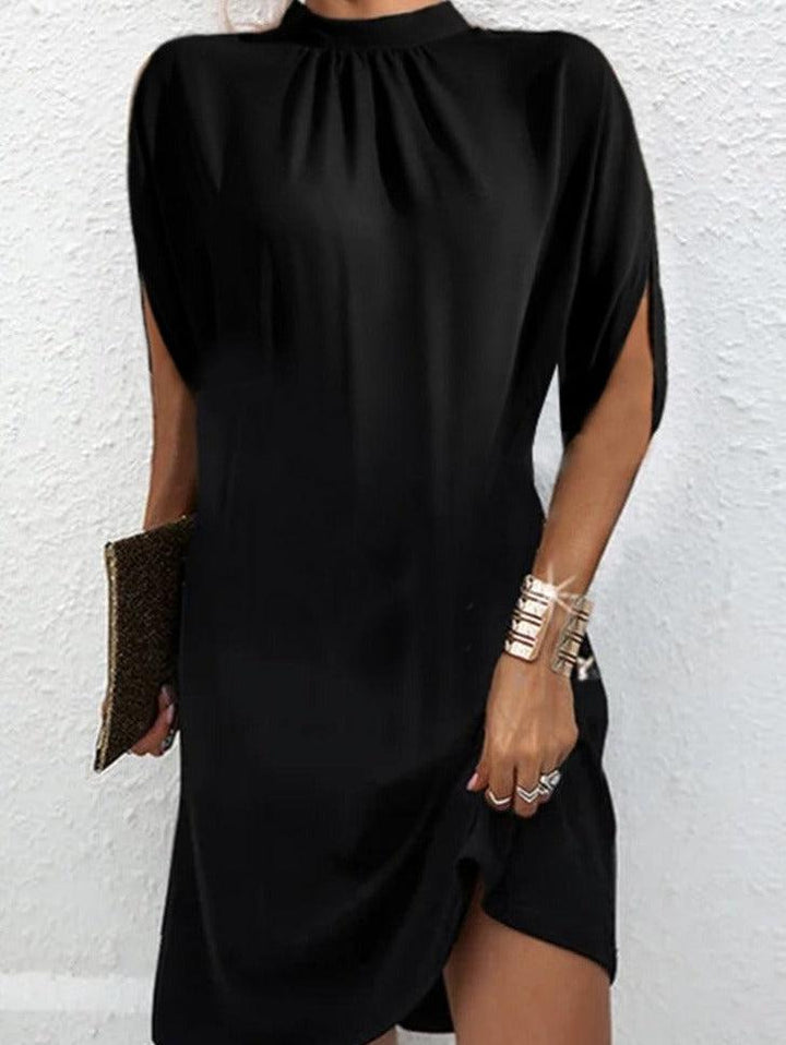 Women's black mock neck mini dress with elegant slit sleeves. Versatile shift design for casual or evening wear.
