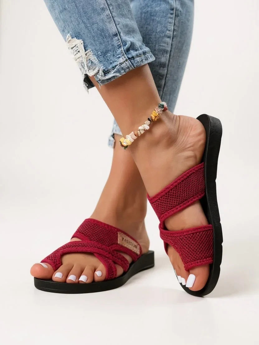 Women's open-toe slides with toe loop, deeply cushioned for comfort. Breathable black slip-on sandals, perfect for summer.