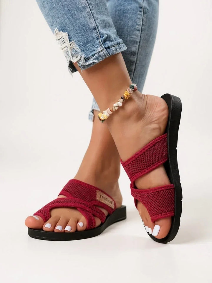 Women's open-toe slides with toe loop, deeply cushioned for comfort. Breathable black slip-on sandals, perfect for summer.