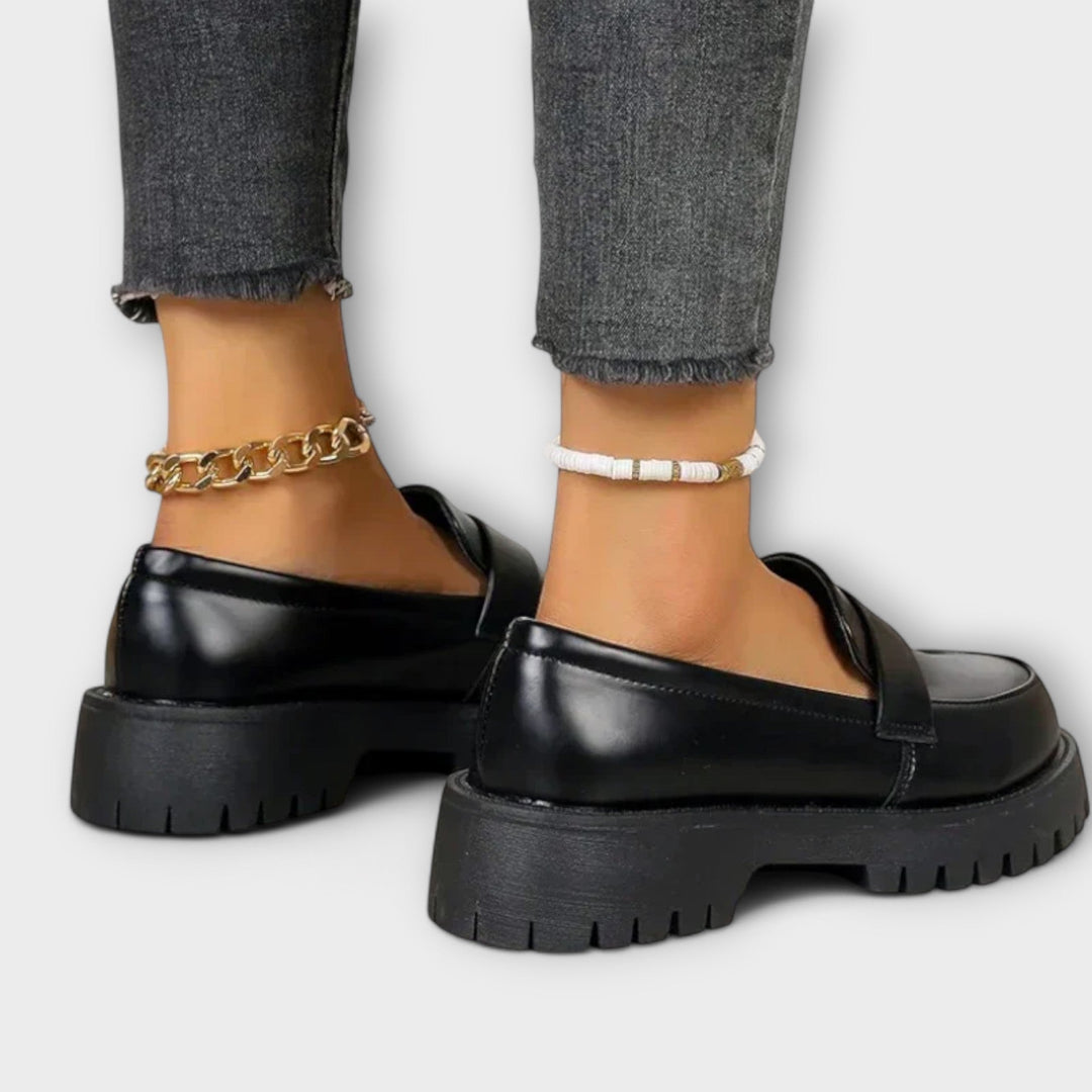 Stylish women's black orthopaedic loafers with arch support. Slip-on design for comfortable everyday wear & elegance.