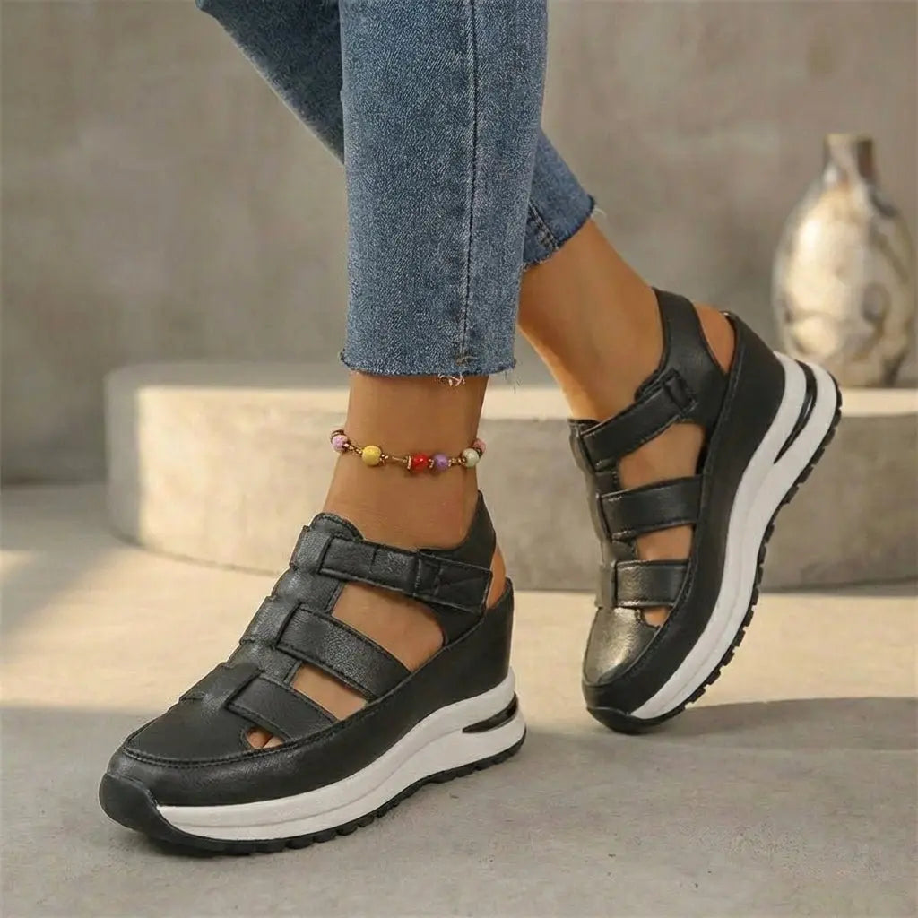 Women's black orthopedic platform trainers with cutout details, closed-toe design, offering supportive comfort & modern style.