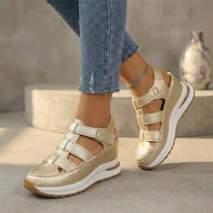 Modern gold orthopedic platform trainers for women, featuring a cutout design, closed-toe, & adjustable comfort fit.