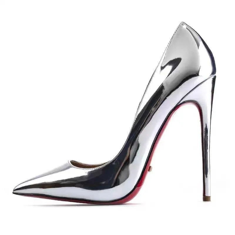 Side profile of a woman wearing shiny black patent stiletto heels, 4.75 inch heel.
