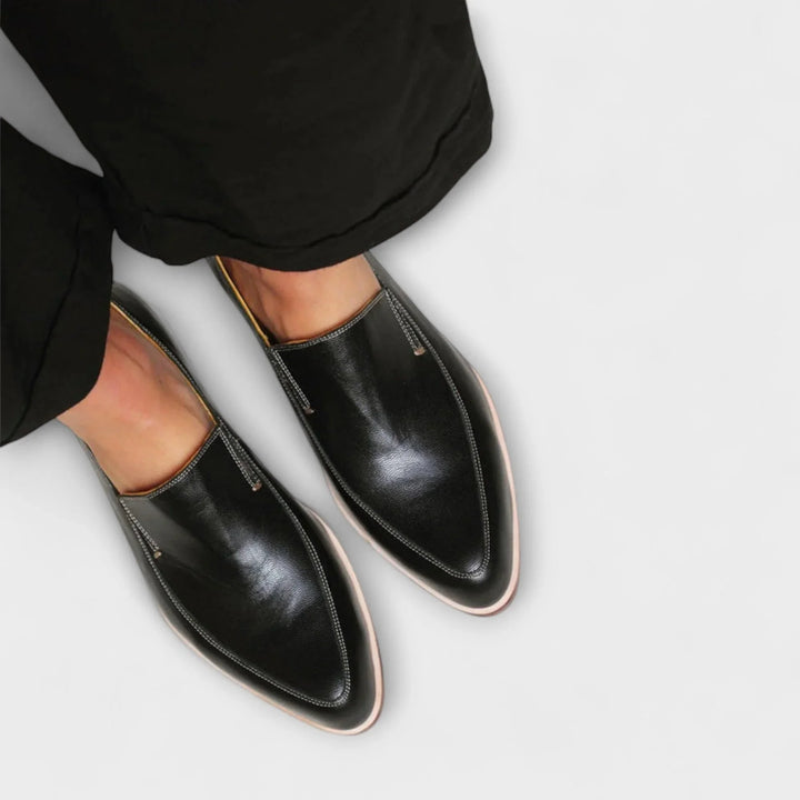Versatile women's black pointed-toe loafers. Easy slip-on design with a comfortable low heel for all-day wear.