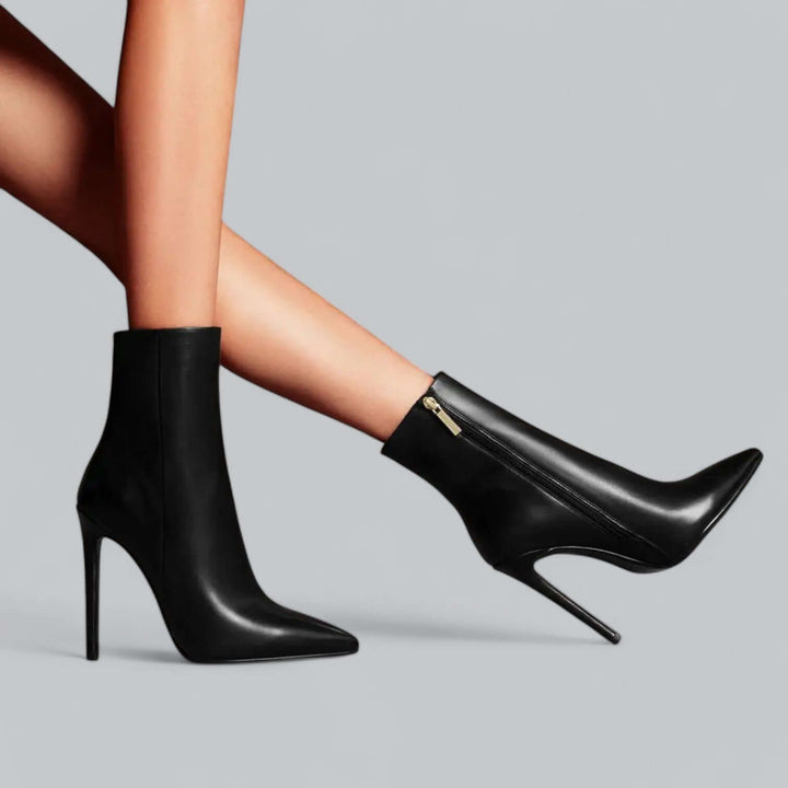 Sleek black pointed toe stiletto ankle boots for women, offering a sophisticated winter boot option.