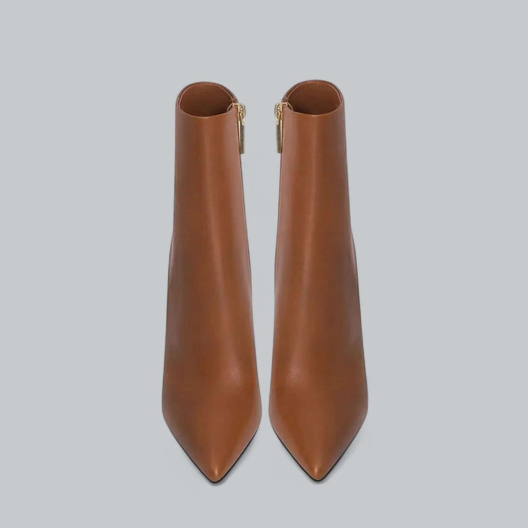 Close-up of the sleek stiletto heel and pointed toe on these elegant women's ankle boots.