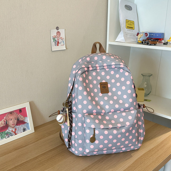 Cute women's polka dot school backpack, stylish and functional for students. Ideal travel daypack.