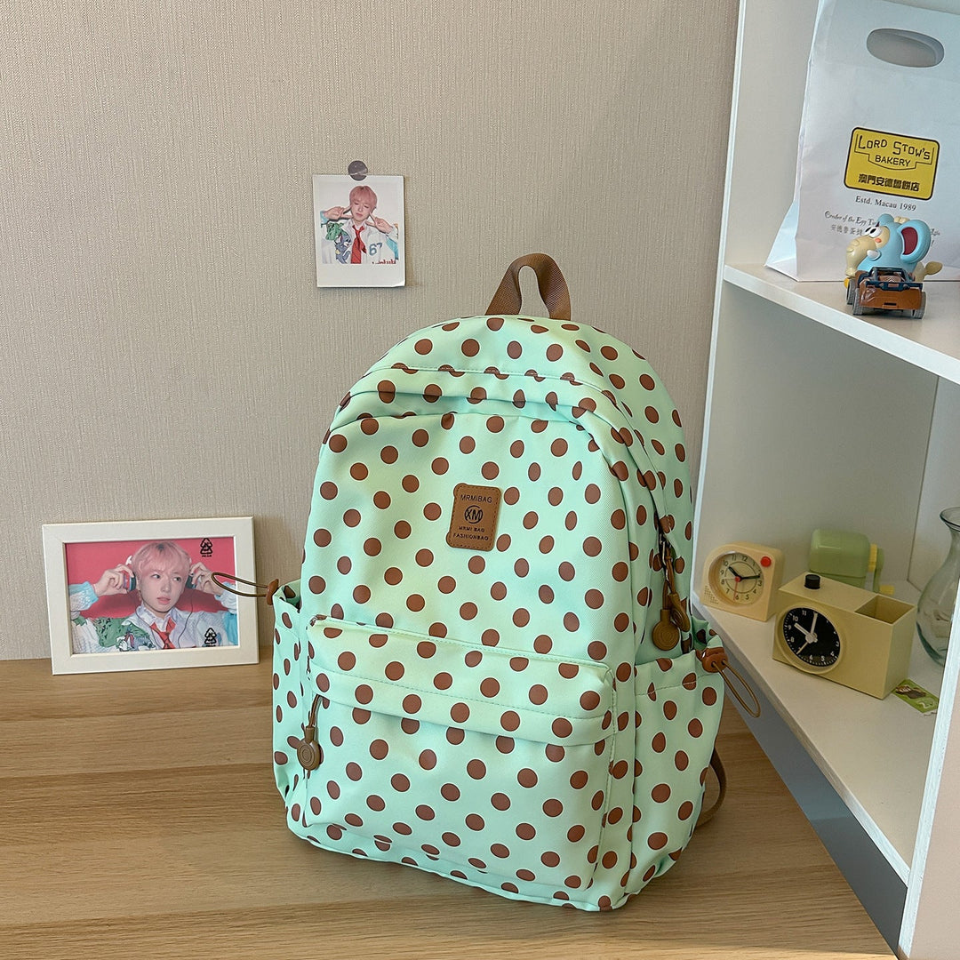 Black & white polka dot women's casual backpack, durable fabric, great for school, travel, or daily commute.