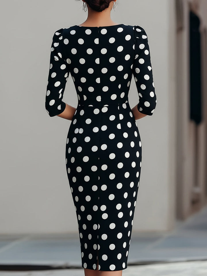 Women's black & white polka dot halter neck bodycon midi dress. Elegant for cocktails & evening events.