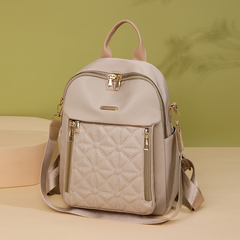 Stylish quilted women's backpack, multi-compartment design in durable fabric, ideal for school, work, or daily fashion.